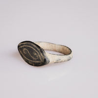 Medieval bronze ring Radulf angled view showing engraved navette bezel and hoop taper
