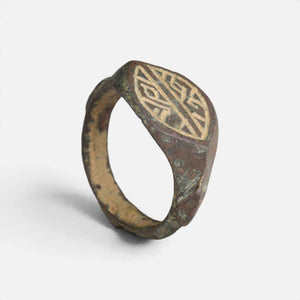 Medieval bronze ring 'Radwin' shows its engraved navette bezel and complete hoop at an angle.