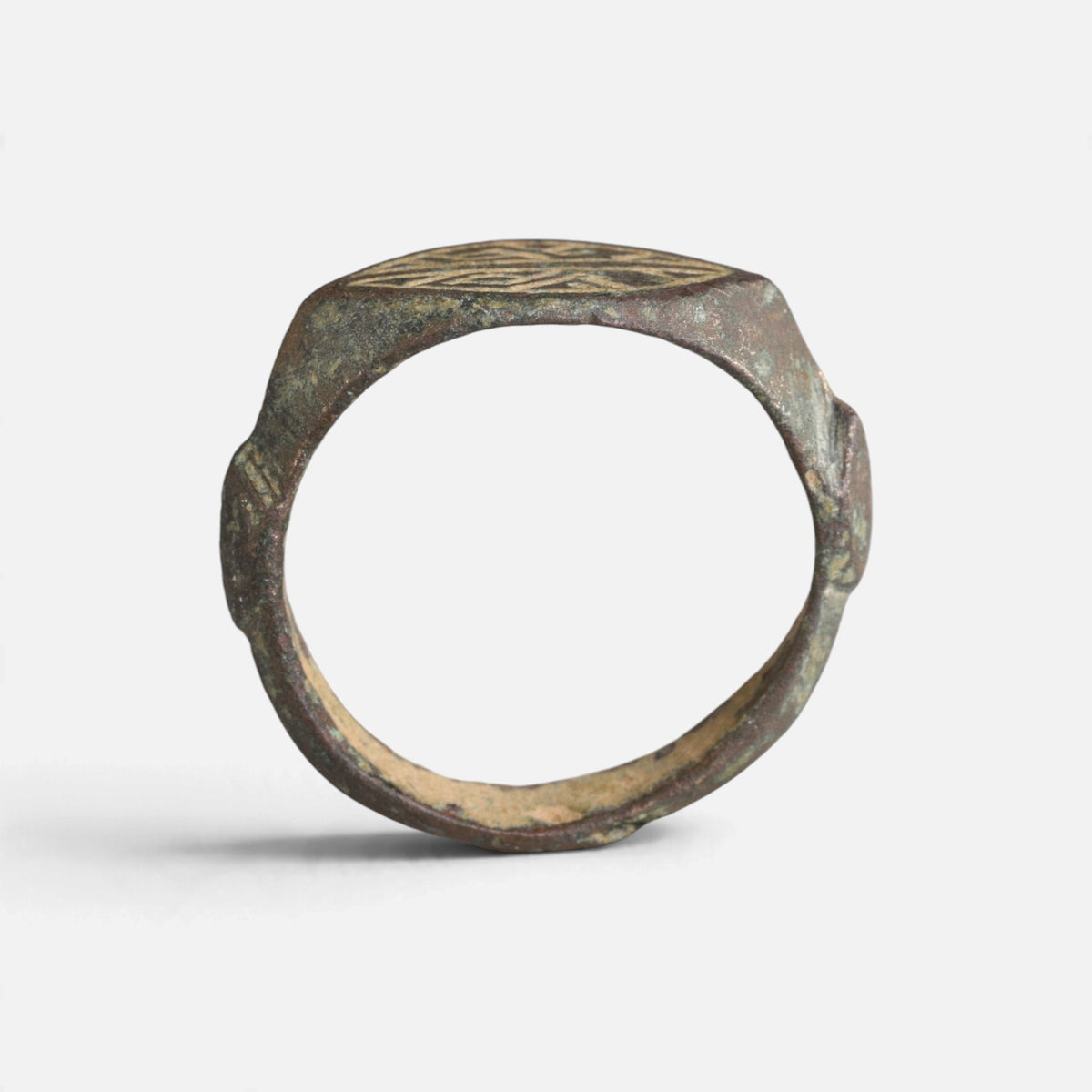 Medieval bronze ring 'Radwin' shows its complete hoop and the thin bezel edge in profile.