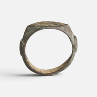 Medieval bronze ring 'Radwin' shows its complete hoop and the thin bezel edge in profile.