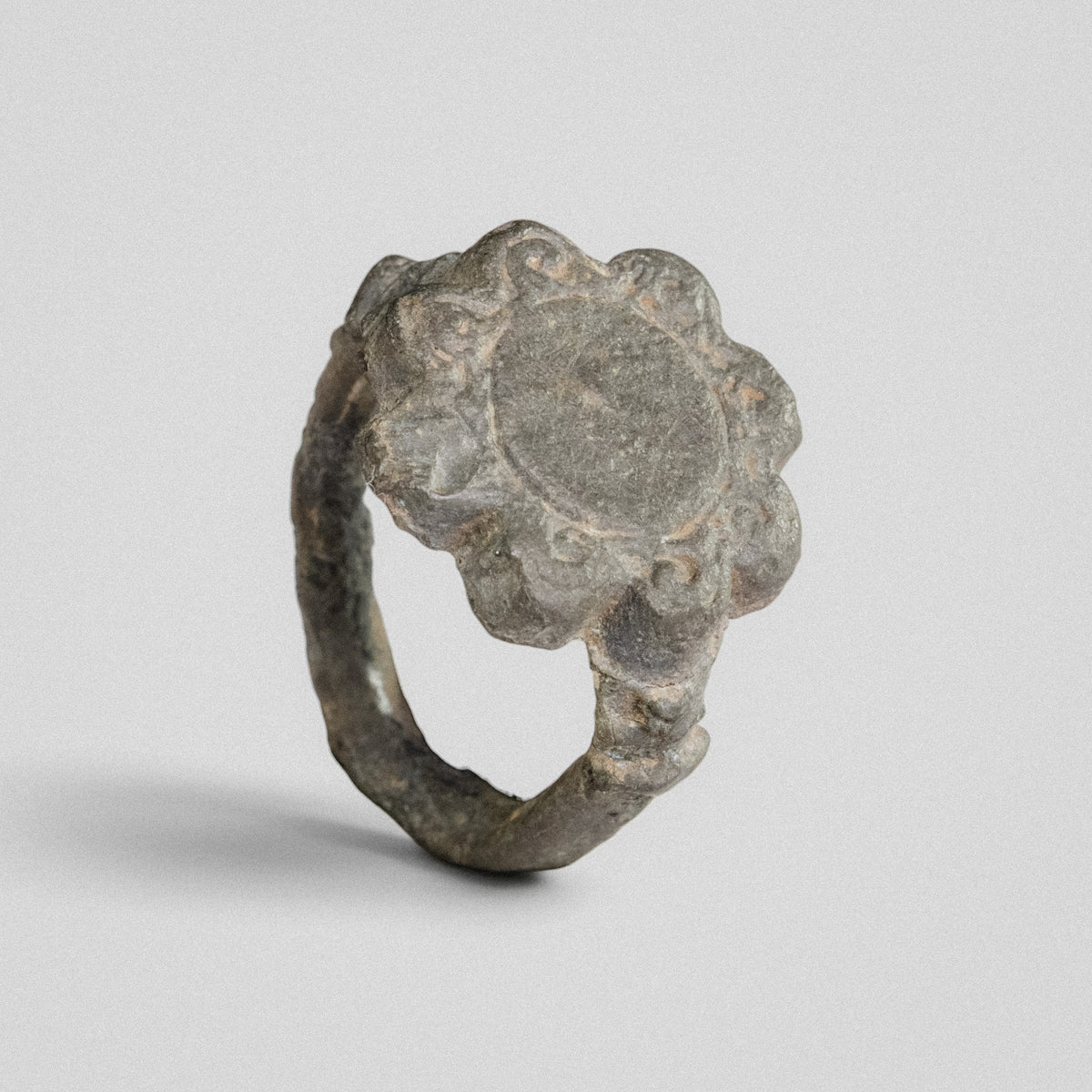 Medieval bronze ring Rosalind showing scrolled petals framing a plain central field