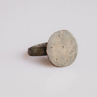 Medieval bronze ring Rurik shown at angle revealing filed bezel and tapered D-section hoop