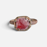 Medieval bronze ring 'Rutheris' shows the red face of its setting from the front.