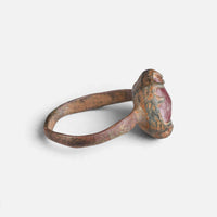 Medieval bronze ring 'Rutheris' shows its raised red setting edge and thin hoop from the side.