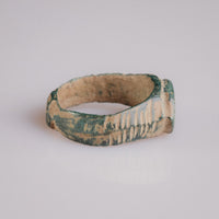 Medieval bronze ring Tamgar, profile view with malachite patina and burial encrustation