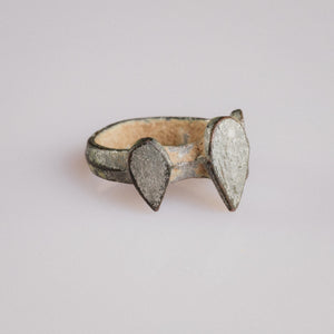 Medieval bronze ring 'Trivena' three-quarter view revealing the plain D-section hoop and central bezel