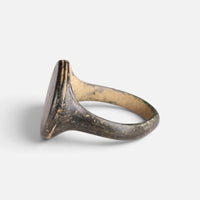 Medieval bronze ring 'Ventaris' shows its broad bezel edge and hoop from the opposite side.