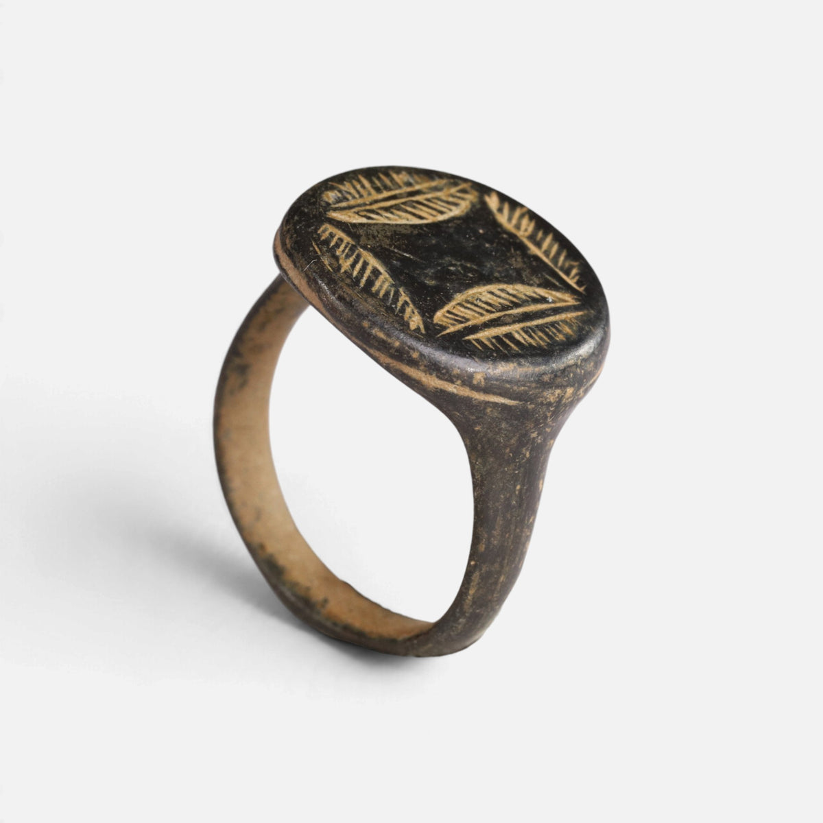 Medieval bronze ring 'Ventaris' shows leaf-like bezel engraving and the complete hoop at a higher angle.