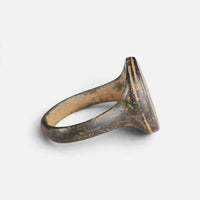 Medieval bronze ring 'Ventaris' shows its broad bezel edge and tapering hoop from the side.