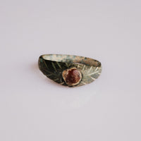 Medieval bronze ring Vetrona with reddish cabochon and radiating striated shoulders, front view