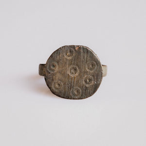 Medieval bronze signet ring Rurik with eight ring-and-dot motifs on circular bezel, top view