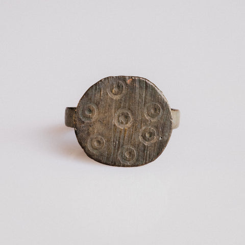 Medieval bronze signet ring Rurik with eight ring-and-dot motifs on circular bezel, top view