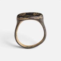 Medieval bronze ring 'Ventaris' shows its full hoop and the edge of its broad oval bezel in profile.