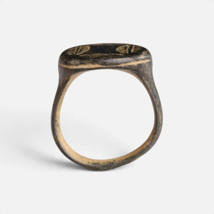 Medieval bronze ring 'Ventaris' shows its full hoop and the edge of its broad oval bezel in profile.