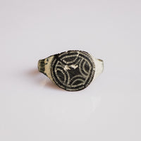 Medieval bronze signet ring Vitalya with engraved quatrefoil and interlace bezel, top view