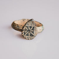 Medieval bronze signet ring Zvezdan with engraved eight-rayed star on shield-shaped bezel