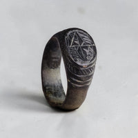 Medieval bronze talismanic ring Vespasia with engraved eight-pointed star bezel and hatched border