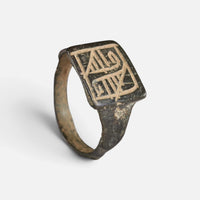 Medieval Islamic bronze ring 'Rashida' shows angular strokes on its rectangular bezel above the complete hoop.