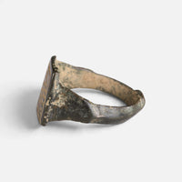 Medieval Islamic bronze ring 'Rashida' shows its bezel edge and broad shoulder from the opposite side.