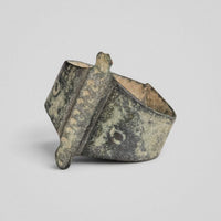 Medieval bronze ring Wistanoc, angled front view of the punched bar, both tabs and a shoulder annulet