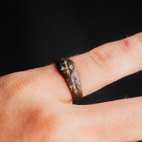 Medieval bronze ring Radenko worn on a finger, cross pattee bezel facing up