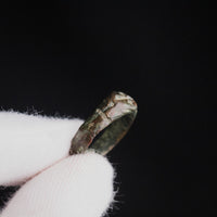 Medieval bronze ring Radenko held between gloved fingers, interior of the hoop visible