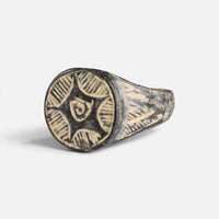 Medieval bronze ring 'Aldebrand' shows its round geometric bezel and shoulder from another front angle.