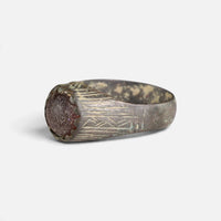 Medieval bronze ring 'Radwina' shows its reddish setting and shoulder engraving from the opposite angle.