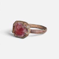 Medieval bronze ring 'Rutheris' shows its red setting from the opposite front angle.