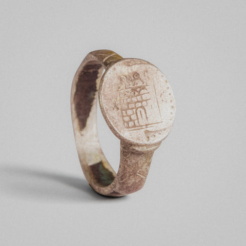 Medieval silver ring Turrisar with heraldic castle bezel in relief, three-quarter view