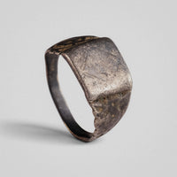 Medieval silver ring Vidomir with worn square bezel, three-quarter view
