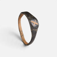 Byzantine bronze ring 'Isidoros' shows its X-shaped bezel mark and complete hoop at an angle.