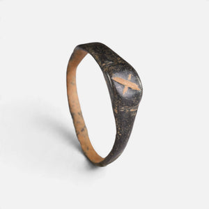 Byzantine bronze ring 'Isidoros' shows its X-shaped bezel mark and complete hoop at an angle.