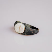 Overhead view of Roman bronze ring Numerius intaglio bezel with altar and flame motif