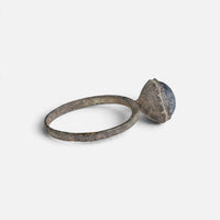 Byzantine bronze ring 'Kaloira' shows the edge of its raised setting and thin hoop from the side.