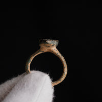 Profile shot of medieval bronze ring Zvezdan showing raised bezel and burial patina