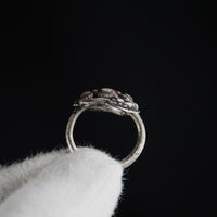 Profile shot of Roman silver ring Ophidius on a gloved hand, showing hoop thickness and bezel elevation