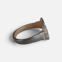Byzantine bronze ring 'Heliona' shows its thin bezel edge and broad hoop from the side.