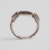 Profile view of Roman silver ring Veneria showing round-section hoop and fixed plate and wound wire