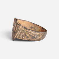 Medieval bronze ring 'Radbert' shows its engraved shoulder and bezel edge from the opposite side.