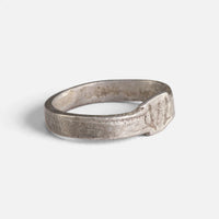 Roman silver ring 'Sextus' shows its small incised bezel and broad flat band at an angle.