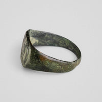 Rear profile of Roman bronze ring Equirius with malachite green corrosion across surface