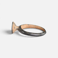 Byzantine bronze ring 'Peristerios' shows its bezel edge and narrow hoop from the opposite side.