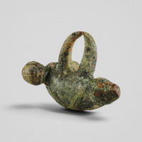 Rear three-quarter view of Roman bronze pendant 'Felix' showing dorsal loop and body