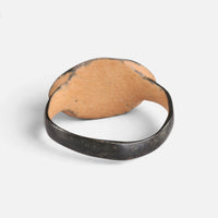 Byzantine bronze ring 'Okellina' shows the plain back of its oval bezel and the inside of the hoop.