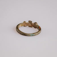 Rear view of medieval bronze ring Cruciata with malachite and cuprite patina on the band