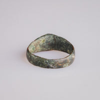 Rear view of medieval bronze ring Radenko showing worn band and layered patina.