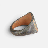 Roman bronze ring 'Mercurialis' shows its broad inner shoulder and the back of its hoop at an angle.