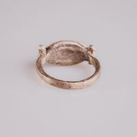 Rear view of Roman silver signet ring Numeria showing the plain tapered hoop and swivel bezel construction