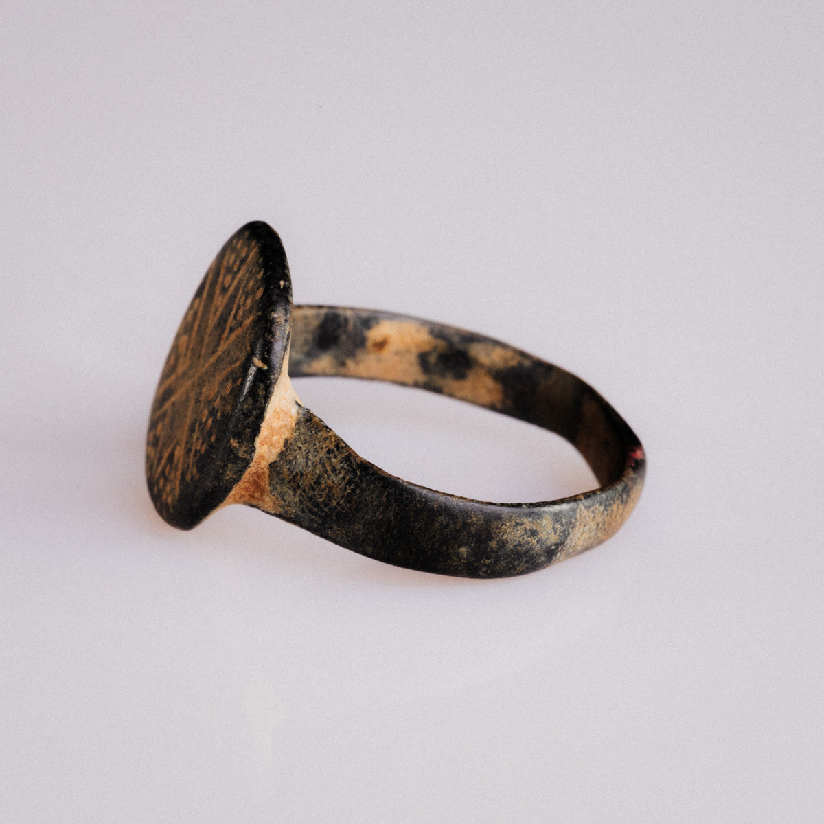 Reverse angled view of Byzantine bronze ring Stellaris showing hoop patina and cuprite traces